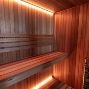 LeisureCraft CT Element Studio Indoor Sauna shown with wooden interior and glass door, designed for home relaxation.